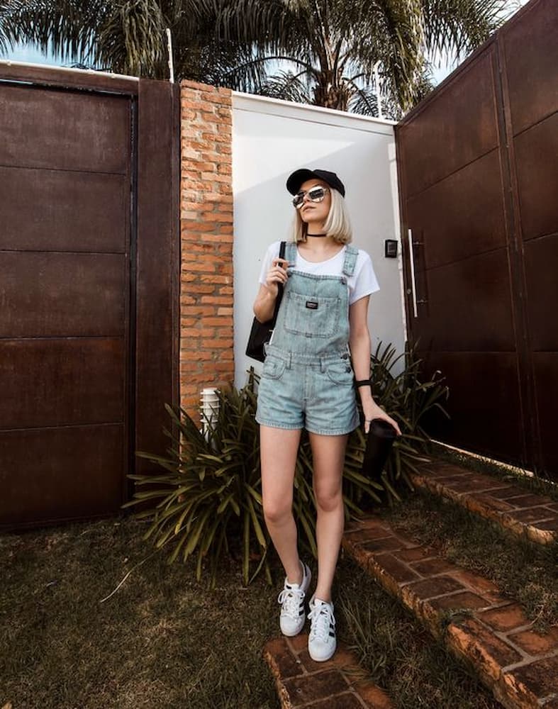 look básico com jardineira jeans curta tênis e camiseta